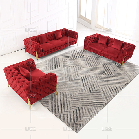 Modernes Sofa aus getuftetem Stoff mit goldenen Beinen